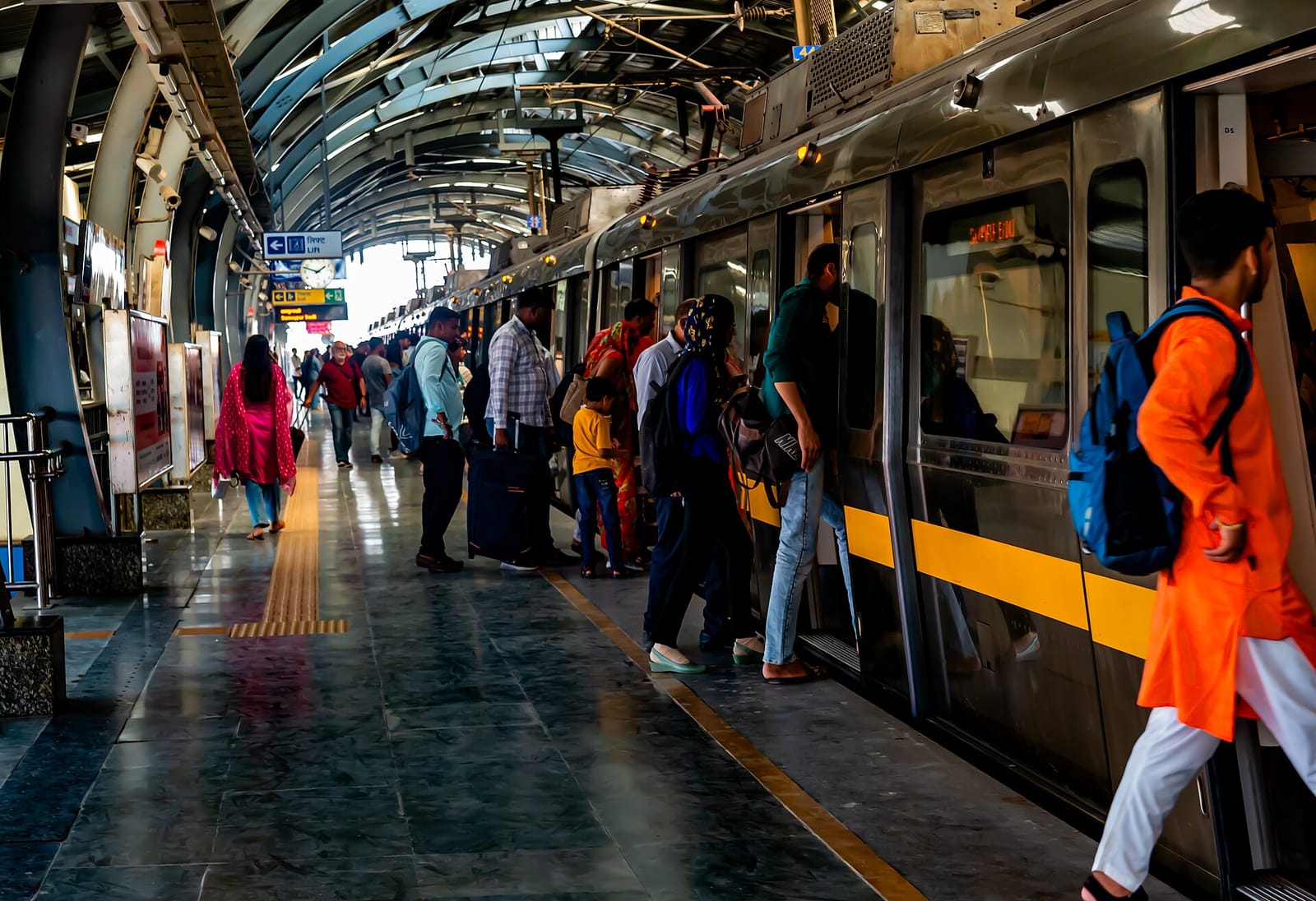 File photo: Passengers board a train at a Delhi Metro station