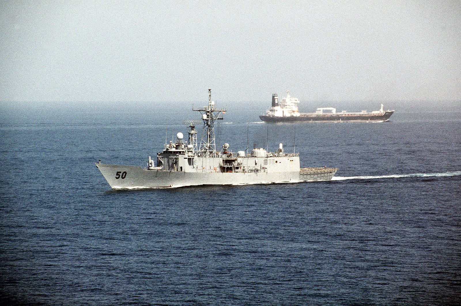File photo: U.S. frigate passes a tanker after transiting Hormuz, 1990